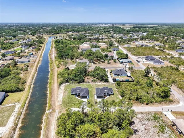 Birds eye view of property featuring a residential view and a water view