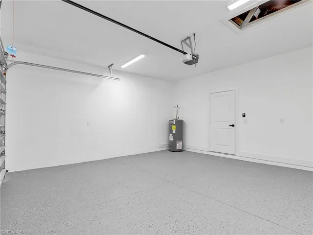 Garage with water heater and a garage door opener