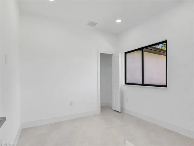 Unfurnished room featuring baseboards and recessed lighting