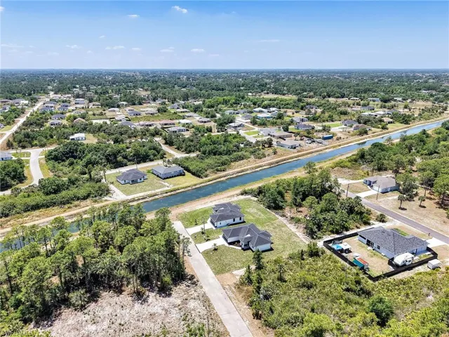 Birds eye view of property featuring a residential view and a water view
