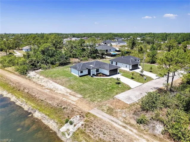 Birds eye view of property with a water view