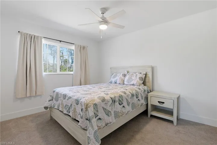 Bedroom featuring a ceiling fan and carpet flooring