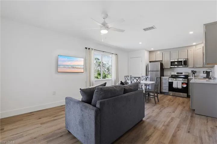 Living area with light wood-style floors, recessed lighting, and ceiling fan