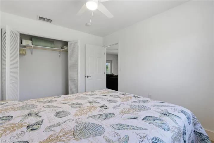 Bedroom featuring a ceiling fan and a closet