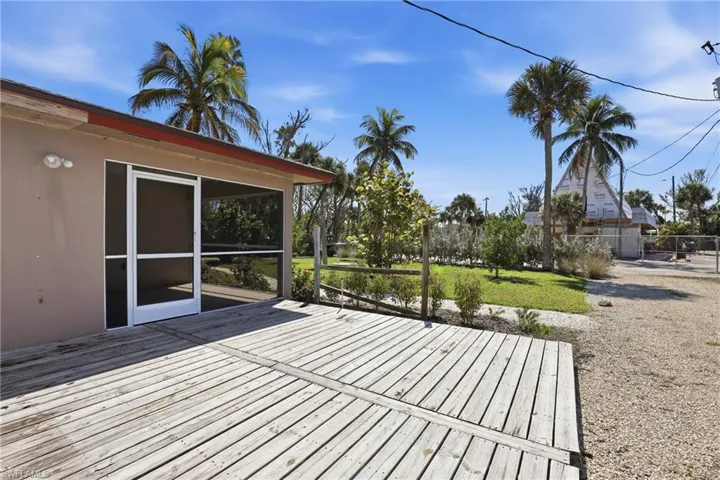 Wooden terrace featuring a sunroom