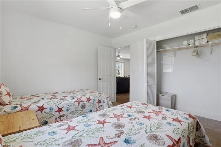 Bedroom featuring ceiling fan, a closet, and carpet floors