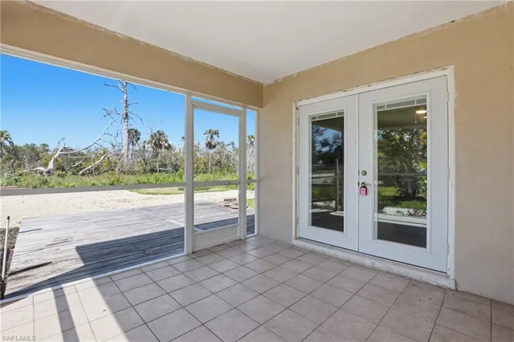 Unfurnished sunroom with french doors