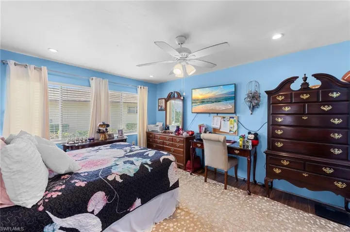Bedroom featuring light wood-style floors, a ceiling fan, and recessed lighting