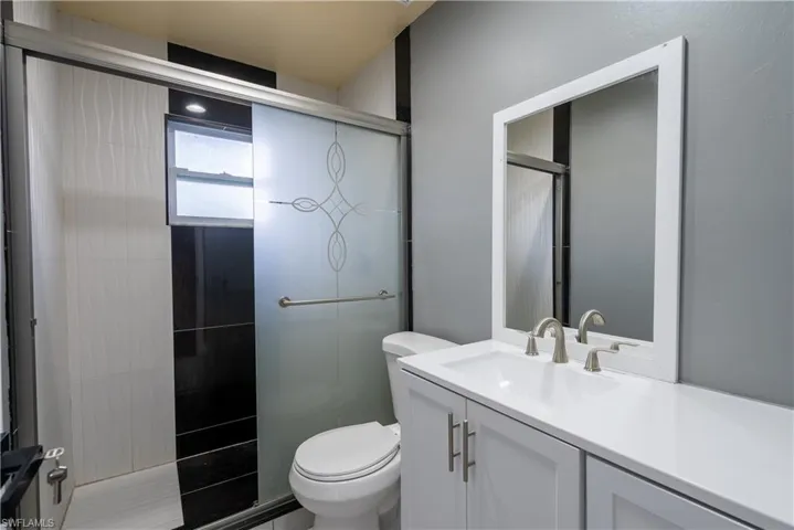 Bathroom featuring vanity and a stall shower