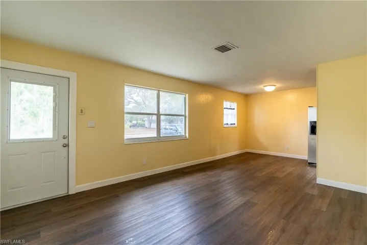 Entrance foyer with dark wood-style flooring