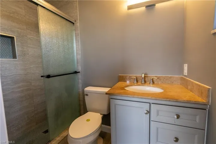 Bathroom with vanity and a stall shower