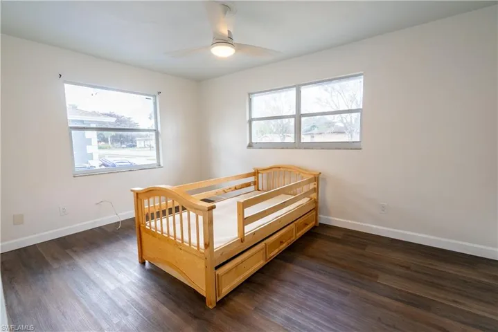 Bedroom featuring dark wood-type flooring and ceiling fan
