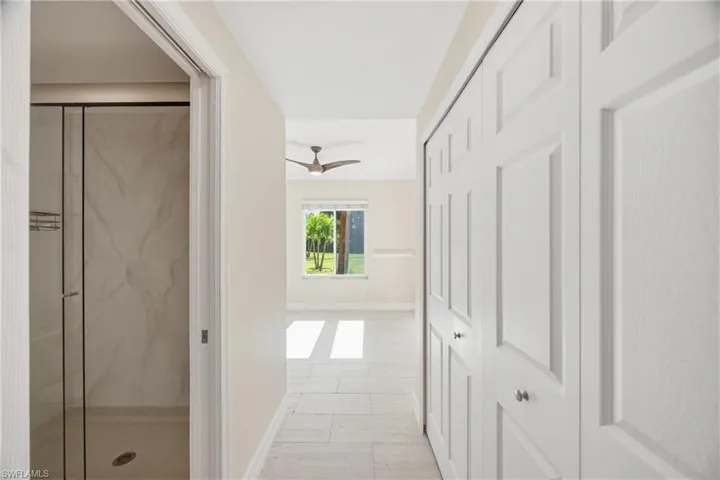 Corridor to guest bedroom featuring closet and access to guest bathroom
