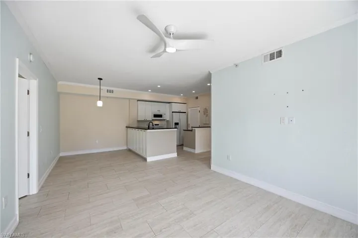 Lliving room featuring crown molding, ceiling fan, tile floors, and recessed lighting