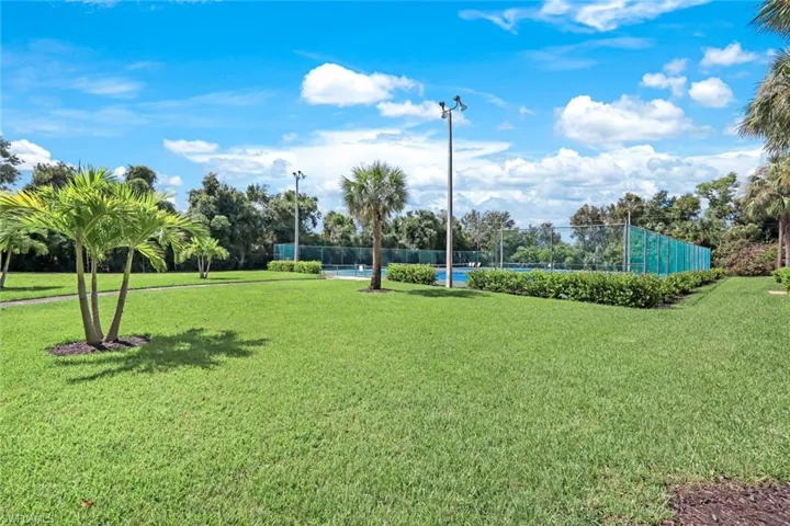 View of home's community with a yard