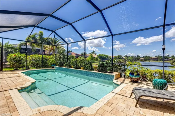 Outdoor pool featuring a patio area and glass enclosure