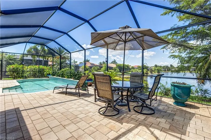 View of patio / terrace featuring an outdoor pool and glass enclosure