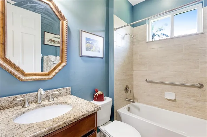 Full bath with toilet, vanity, and bathtub / shower combination