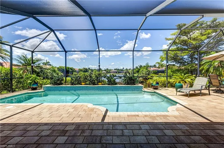Outdoor pool featuring a patio area and glass enclosure
