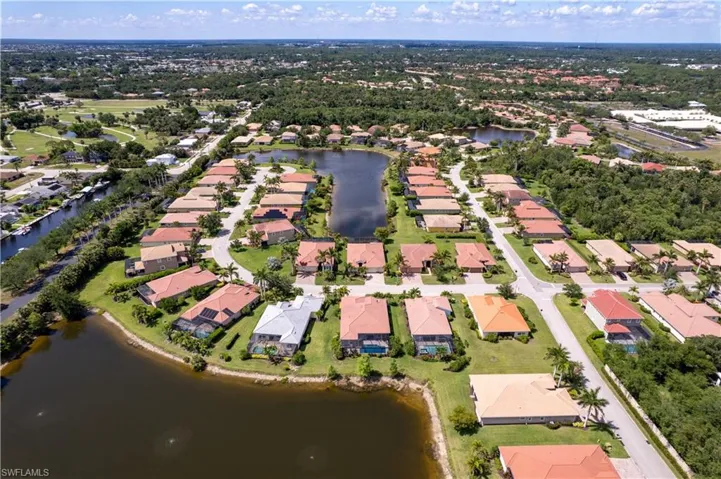 Aerial overview of property's location featuring nearby suburban area and a large body of water