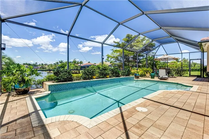 Outdoor pool featuring a patio, a lanai, and a water view