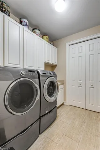 Laundry room featuring cabinet space and separate washer and dryer
