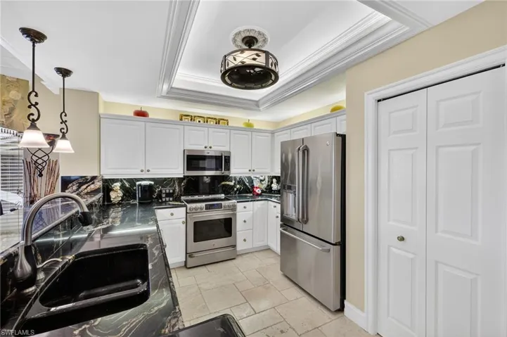 Kitchen with granite counters, stainless appliances, over/under cabinet lighting.