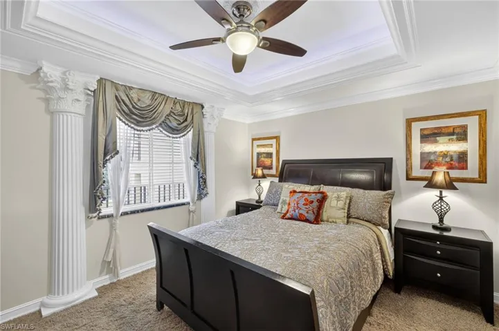 Guest bedroom features tray ceiling with indirect lighting.