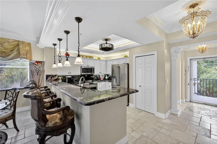 Breakfast bar and foyer with custom lighting and Anderson storm door.