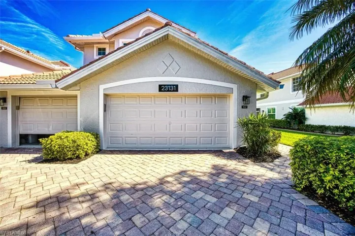 Garage featuring decorative driveway