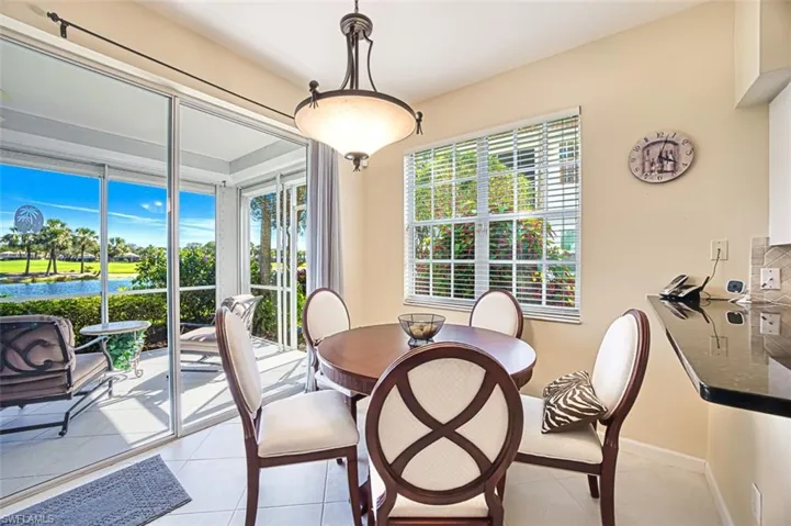 Dining room featuring light tile patterned floors and baseboards
