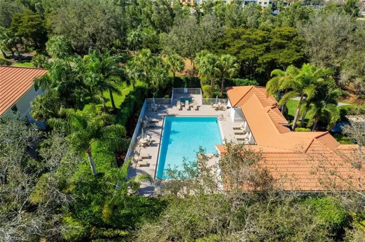 Pool with a patio area and fence