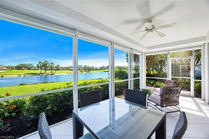 Sunroom / solarium featuring a ceiling fan, a healthy amount of sunlight, and a water view