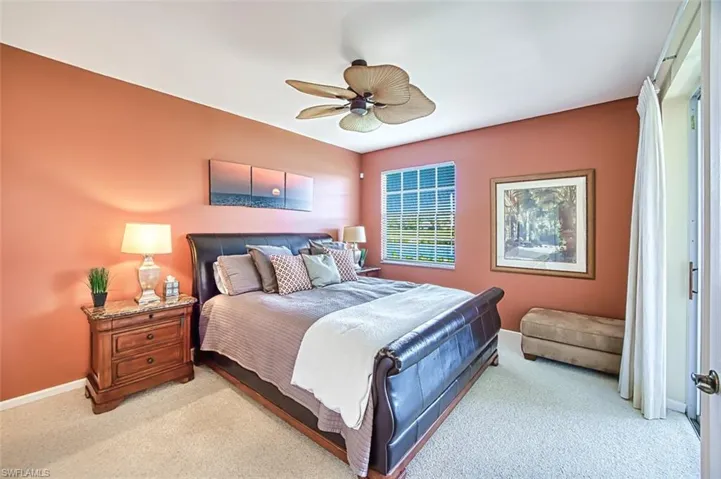 Bedroom with baseboards, ceiling fan, and light colored carpet