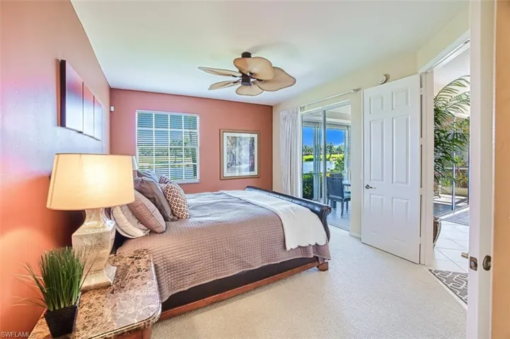 Carpeted bedroom featuring access to exterior and ceiling fan