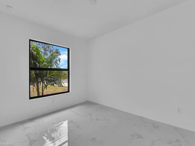 Spare room with marble finish floor