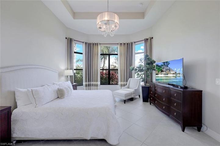 Main bedroom has nice sitting area looking out to the lake and fountain. Tray ceiling.