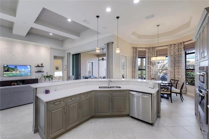 Great room  - note the stacked stone white stone feature wall with four floating shelves. Wall mounted TV will stay. Custom light fixtures throughout the home.