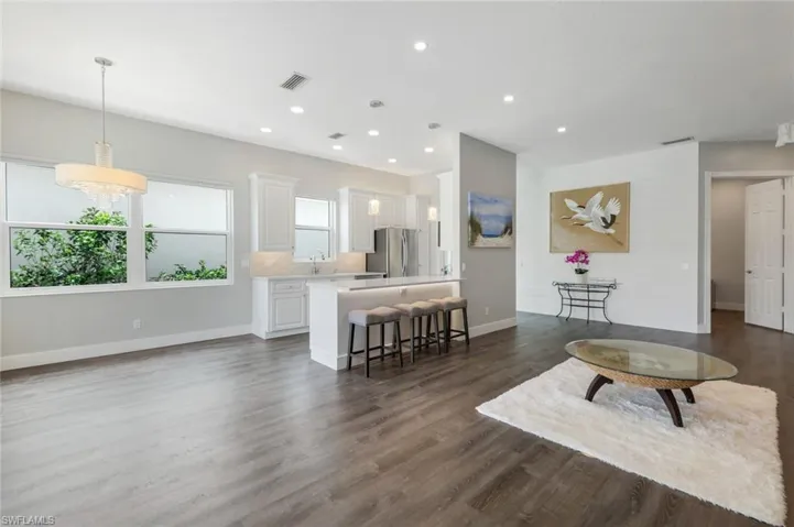 Living area with baseboards, recessed lighting.