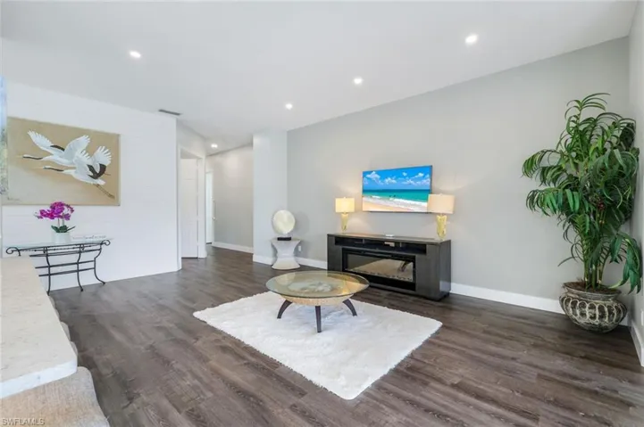 Living room featuring  finished floors, baseboards, and recessed lighting