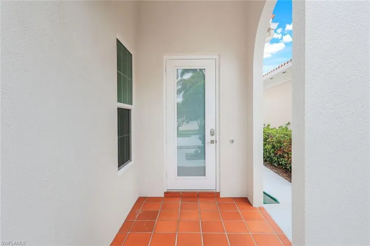 Entrance to property with Impact door and glass. Stucco siding.