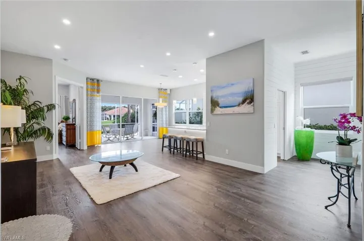 Living area with baseboards, recessed lighting, and wood finished floors