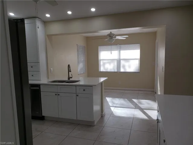 Kitchen featuring white cabinets, a ceiling fan, and recessed lighting