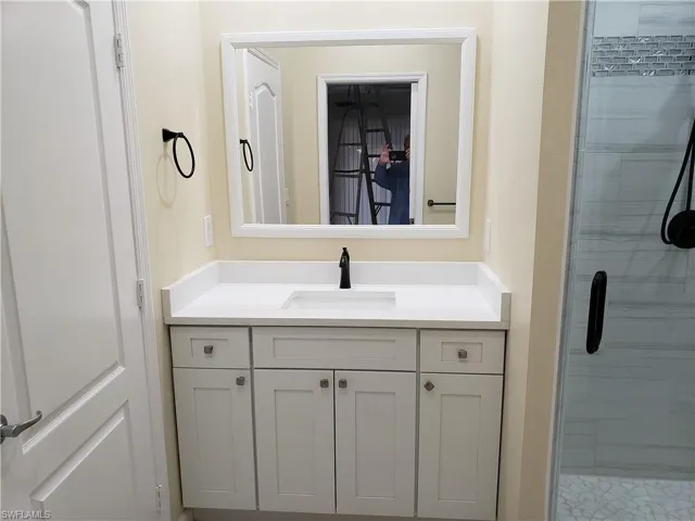 Bathroom featuring vanity and a stall shower