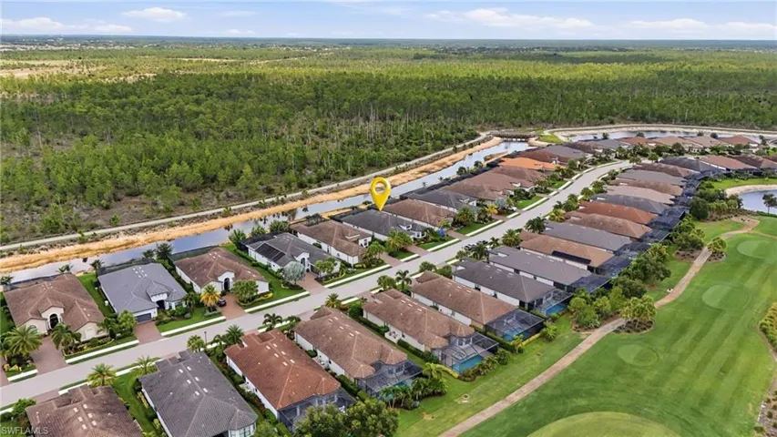 Aerial perspective showcasing a residential community with direct access to a waterway