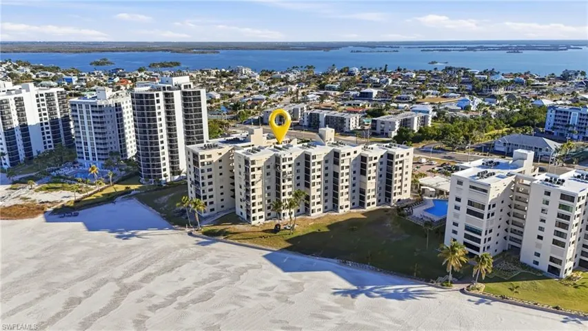 Aerial view of apartment complex and a large body of water