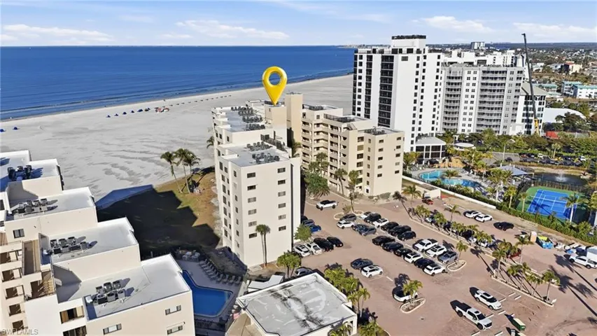 Aerial view of apartment complex and expansive coastline