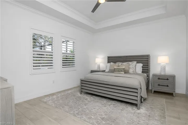 Spacious owner suite is nestled at the back of the home and overlooks the pool and preserve.