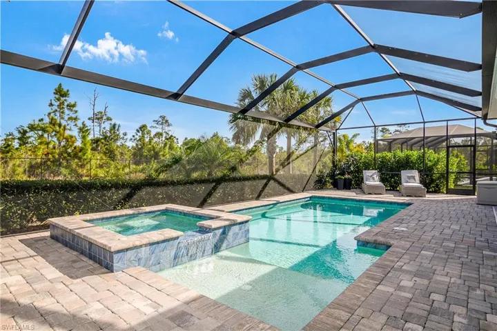 Pool features a spa and sun shelf for your ultimate relaxation.