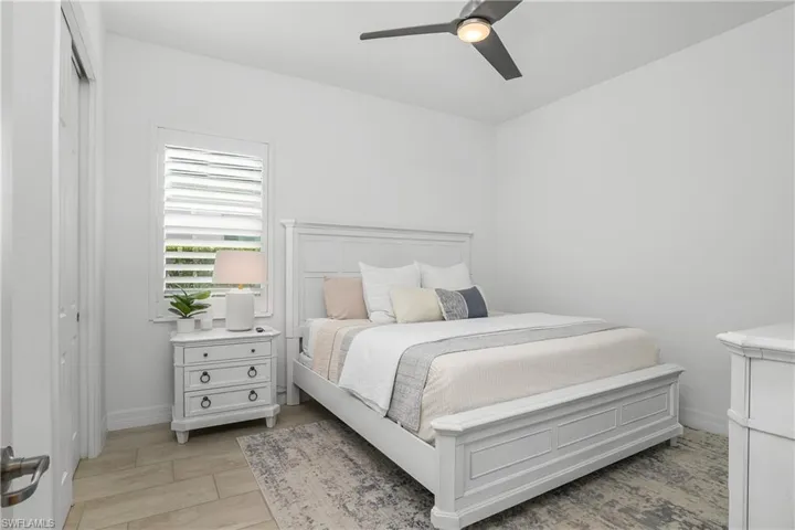 Bedroom #2 is private and features tile flooring & plantation shutters and is located next to a full guest bath.